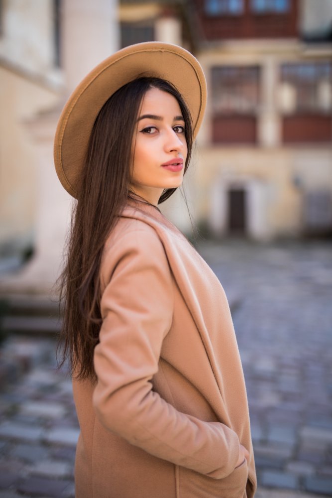 A girl In brown coat And hat
